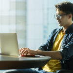Tech Employee with a laptop on the Table